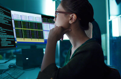 Female researcher in front of computer monitors